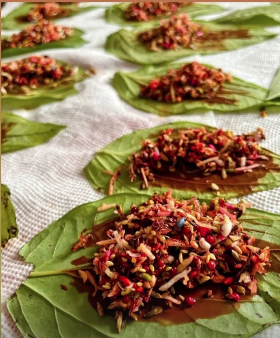 Fresh betel leaves topped with filling, laid out during preparation
