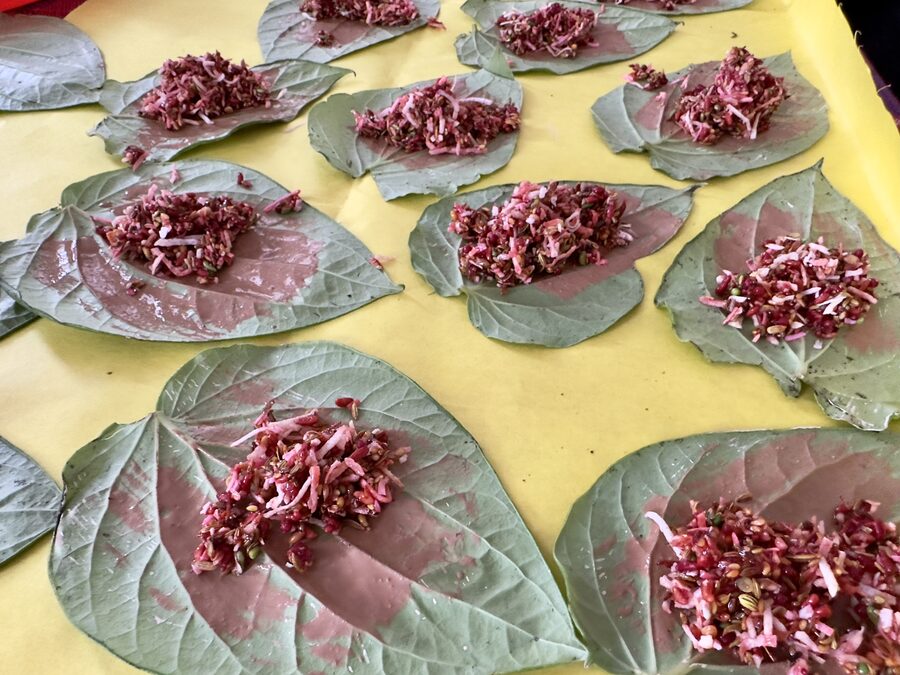 Paan leaves being prepared with rose petals