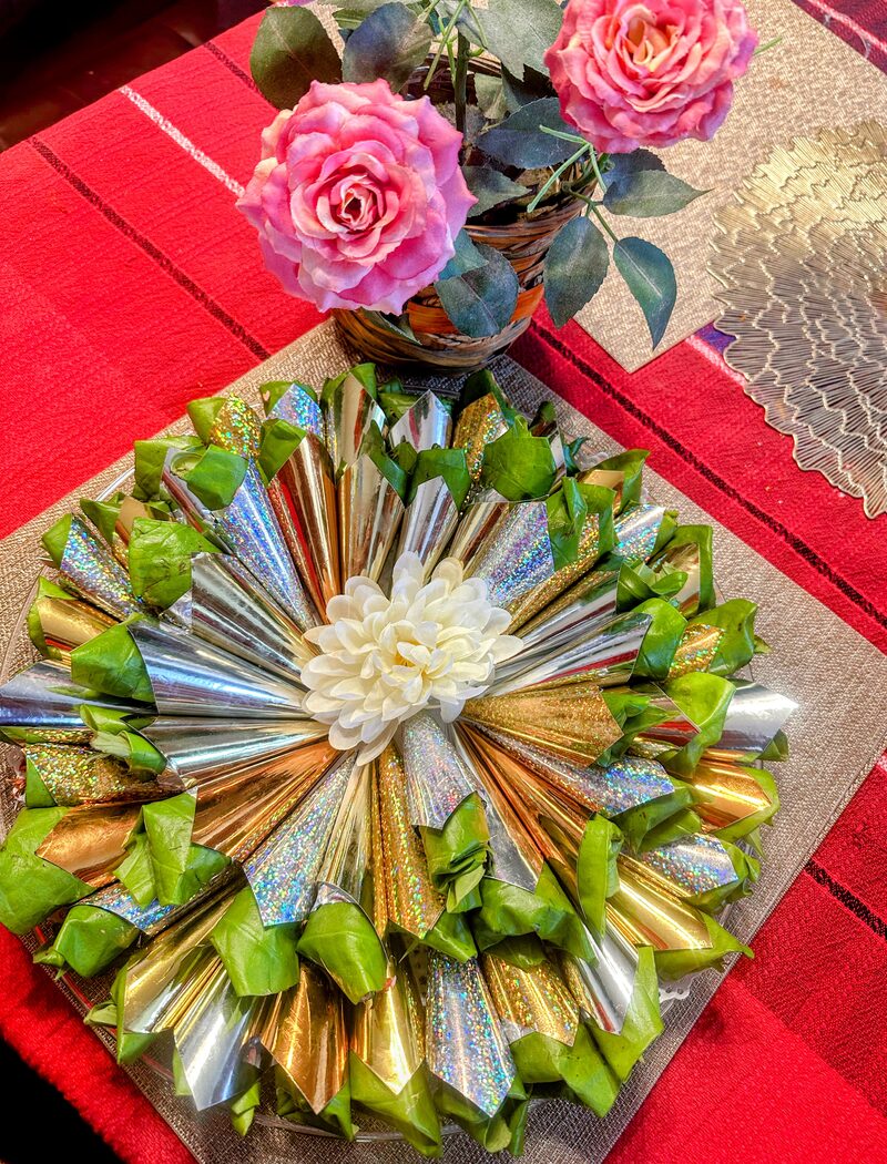 Elegant silver and gold paan platter with pink roses
